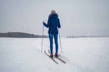 Girl standing on skis and looking forward