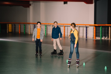 Excited kids fooling around on skater rink