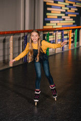 Female roller skater in jeans enjoying childhood