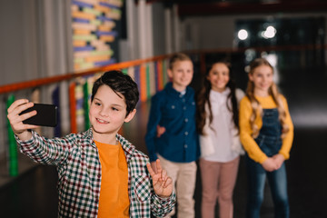 Brunette kid making selfie with best friends