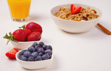 Breakfast with muesli, berries on the white background