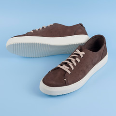 Men's sneakers on a blue background. Top view. Men's footwear. Male shoes