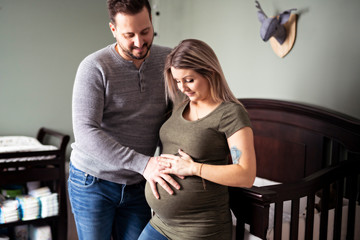 A Young pregnant woman with her husband at home