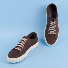 Men's sneakers on a blue background. Top view. Men's footwear. Male shoes