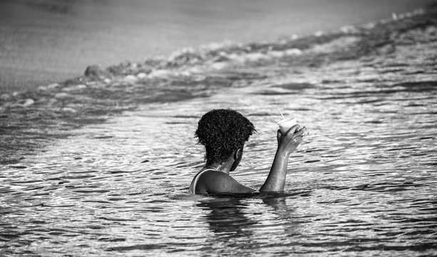 Saint Vincent and the Grenadines,  girl swimming with glass in the hand 