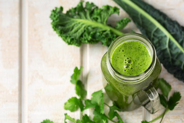 Green Vegetable Juice on a White Wooden Surface with Copy Space
