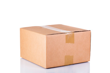 Isolated shot of closed blank cardboard box on white background