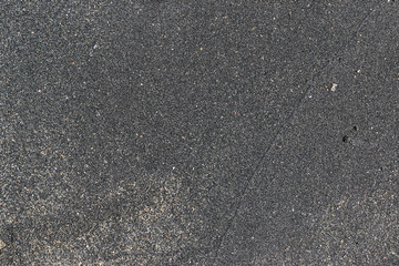 Sandy coast close up. Black sand. Top view