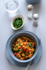 Healthy vegan bowl with quinoa, pumpkin, pepper and carrot on gray wooden background. Selective focus