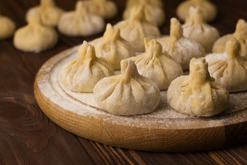 homemade georgian khinkali on wooden background