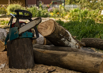chainsaw on the background of sawn logs. firewood for the winter