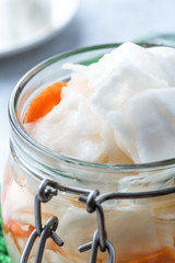 Fermented cabbage in a jar closeup.