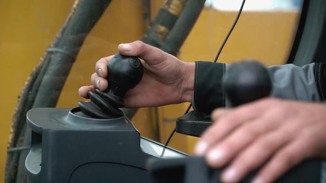 Detailing of the new driver cab excavator. Clip. Driver of the crane arm