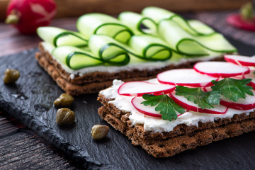 Spring breakfast. Sandwich with ricotta, radish and cucumber.