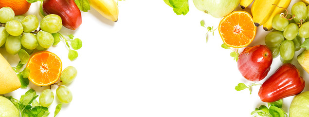 flat lay top view tropical fruits frame background: grape, rose apple, orange, spinach, mango, pear, guava and banana. Healthy drink ingredients. Vegetarian, vegan food concept. Detox. Text space