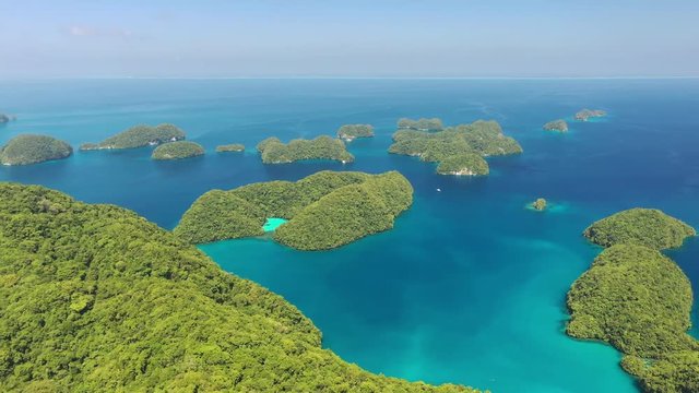 Aerial view of South Rock Islands (Chelbacheb), many lush green islets around Ngeruktabel island, seascape with colorful coral reefs and lagoons - landscape panorama of Micronesia from above, Palau