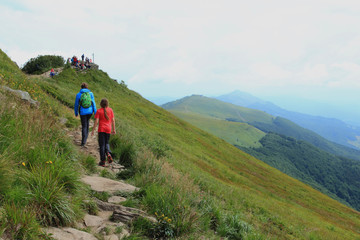 Polonina Welinska. Tourist on trekking path near mountain shelter Puchatek Hut (Chatka Puchatka),...