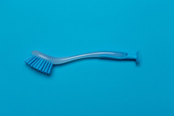 dish washing brush on blue background