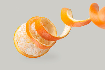 orange peel coiled, peeled orange, orange peeled, on a gray background