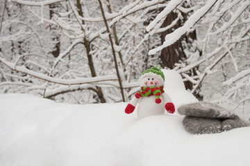 snowman toy in the snowy winter forest or park