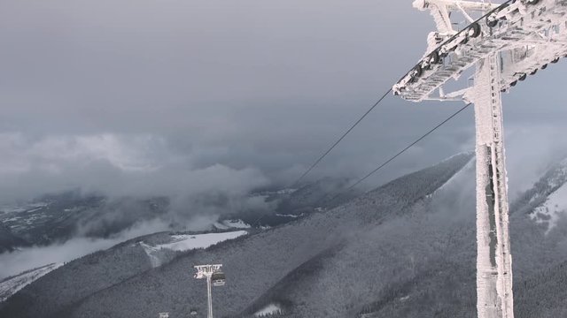 Panning time lapse of ski lifts on the mountain Chleb in Slovakia overlooking a majestic view with clouds.