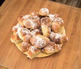 Freshly baked croissants dusted with icing sugar