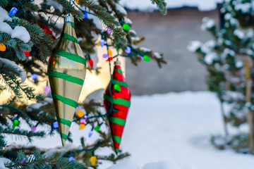 Tree with colorful decoration against snowy ground