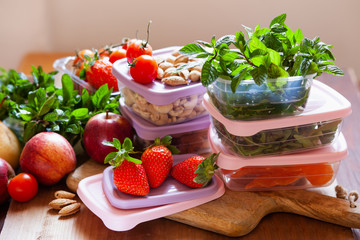 Filled plastic containers to save food, herbs and fruits fresh, concept of economy household