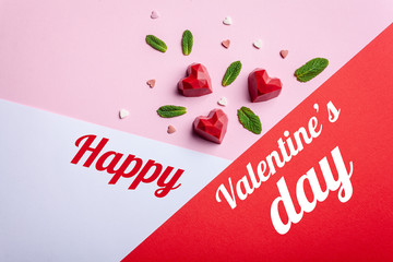 Greeting card with Valentine's Day. Handmade chocolate sweets pastry with strawberry filling, on a tap, rose and white background. Top view, copy space