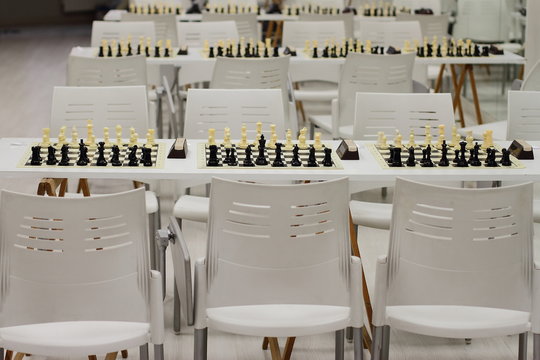 set of chess on a board, ready for competition, white and black set, king, queen, horse figures