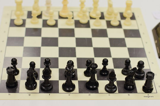 set of chess on a board, ready for competition, white and black set, king, queen, horse figures