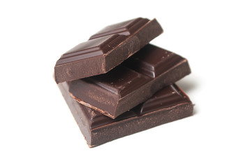 closeup of chocolate blocks pile on white background
