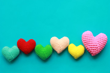 Colorful of Handmade crochet heart on blue background for valentines day - obrazy, fototapety, plakaty