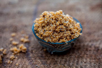 Close up of popular Indian & Asian sweet dish i.e. Malida or churma na ladu or moti chur na ladu in a bowl on brown surface.