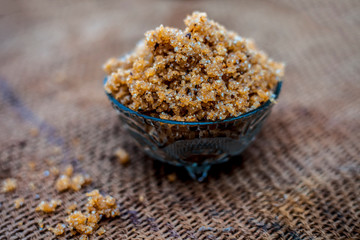 Close up of popular Indian & Asian sweet dish i.e. Malida or churma na ladu or moti chur na ladu in a bowl on brown surface.