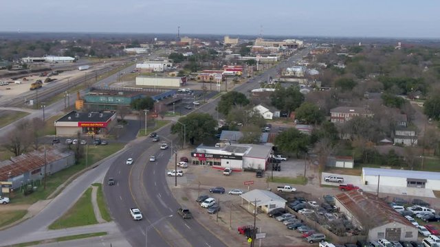 AERIAL: curved street in a small town