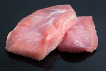 raw meat pork on black table