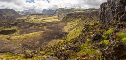 Obraz premium Rocky volcanic nature landscape of Landmannalaugar in Iceland on Laugavegur trek. Green Nordic summer on hiking trail.