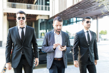 Officers Walking With Globally Known Entrepreneur