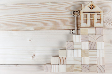 Naklejka na ściany i meble Real estate concept. Small toy wooden house with keys