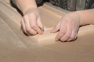 manual grinding of wooden furniture facade in joinery production