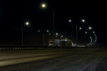 Fototapeta na wymiar trucks moves at night on the highway