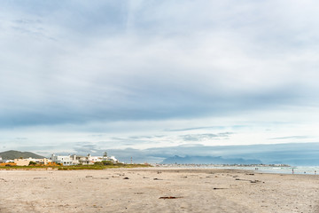 Beach scene, with buildings and people, in Melkbosstrand