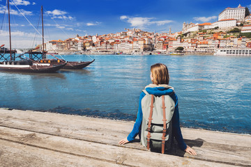 Young woman traveler looking at the Porto city, Portugal. Travel and active lifestyle concept