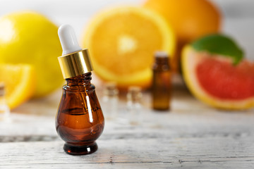 aromatherapy treatment alternative medicine - fruit essential oil bottle on wooden table