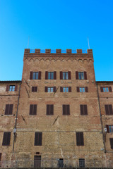 Fototapeta na wymiar Palace Pannochieschi (Palazzo Pannochieschi d'Elci) on the main squre of Siena (Piazza del Campo) on the blue sky background, Tuscany, Italy