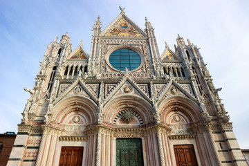 Fototapeta na wymiar Monumental and beautiful facade of Metropolitan Cathedral of Saint Mary of the Assumption, Siena, Tuscany, Italy