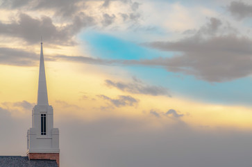 White steeple against cloudy sky in Utah Valley