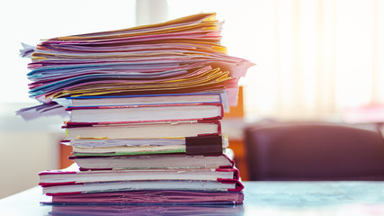 Stack of documents placed on a business desk in a business office.