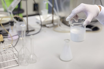 hand with white glove holding Concentrated latex